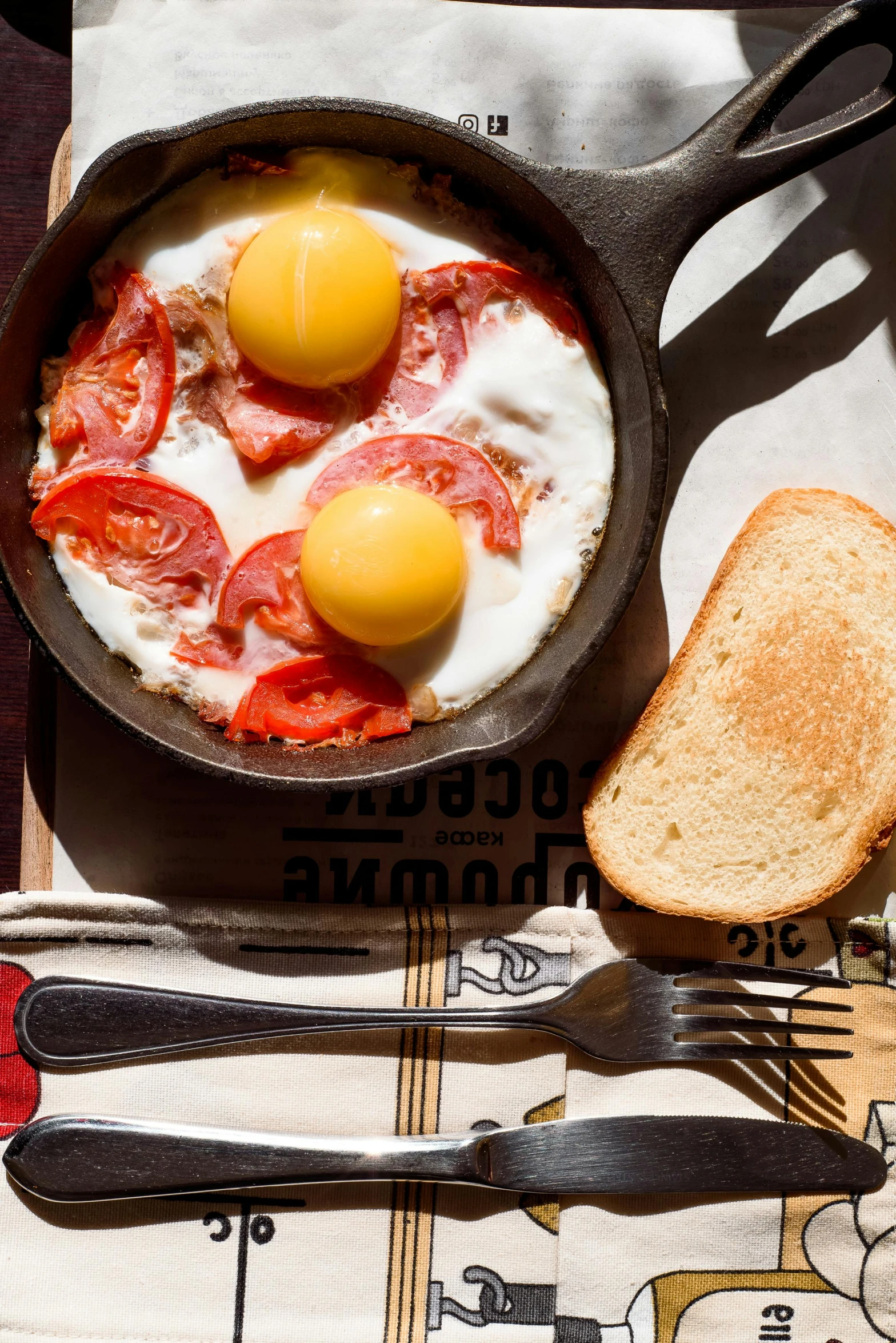 a pan filled with eggs sitting on top of a table, dau-al-set, breakfast at las pozas, portrait shot, toast, getty images