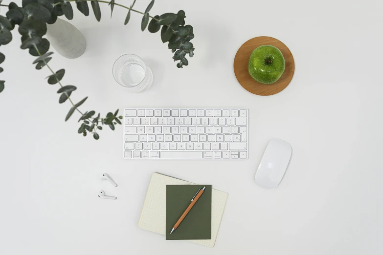 a computer keyboard sitting on top of a white desk, leaf green, various items, no - text no - logo, detailed product image