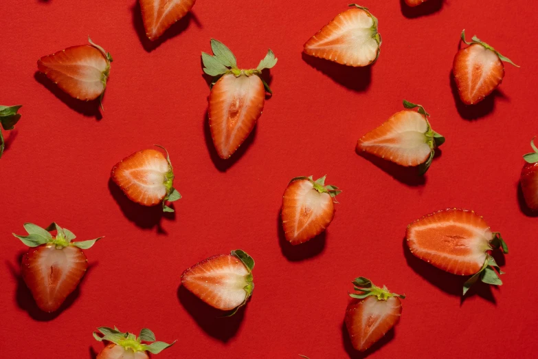 a bunch of strawberries sitting on top of a red surface, by Julia Pishtar, pexels contest winner, perfectly tileable, organics, cosmopolitan, computer wallpaper