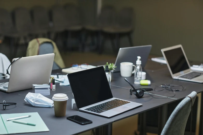 a group of laptops sitting on top of a table, on a desk, ash thorp khyzyl saleem, thumbnail, no people