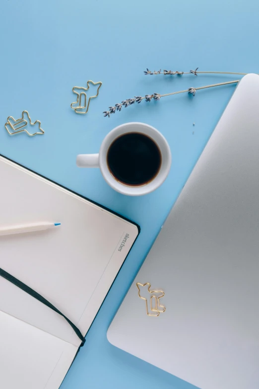 a laptop computer sitting on top of a desk next to a cup of coffee, trending on pexels, postminimalism, cream and blue color scheme, paper quilling, avatar image, 9 9 designs