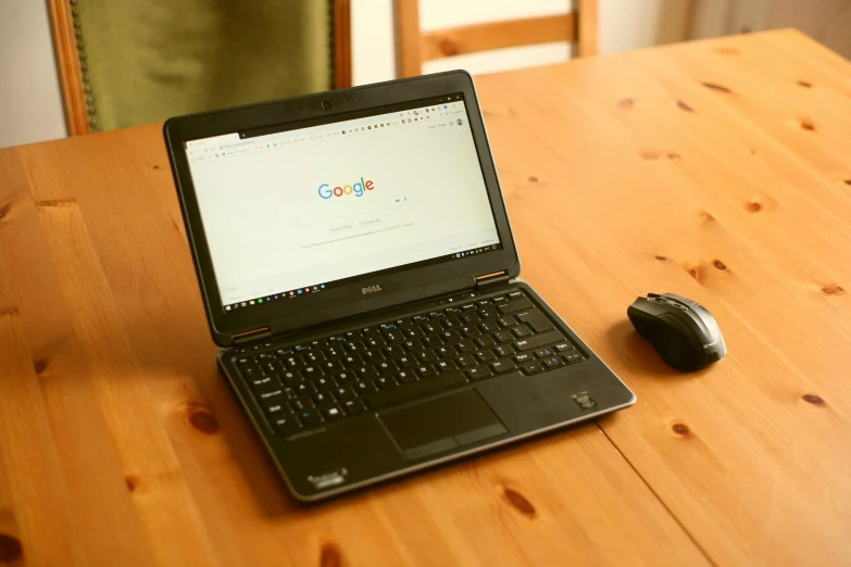 a laptop computer sitting on top of a wooden table, by Carey Morris, google, rectangle, console and computer, thumbnail