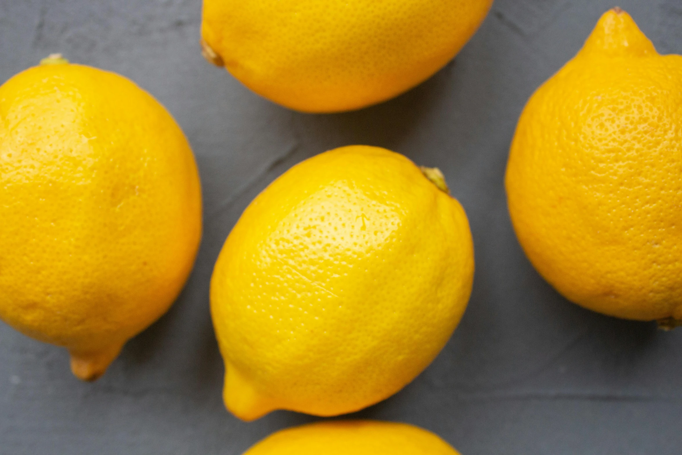 a group of lemons sitting on top of a table, a portrait, trending on pexels, background image, recipe, high-resolution photo, chalk