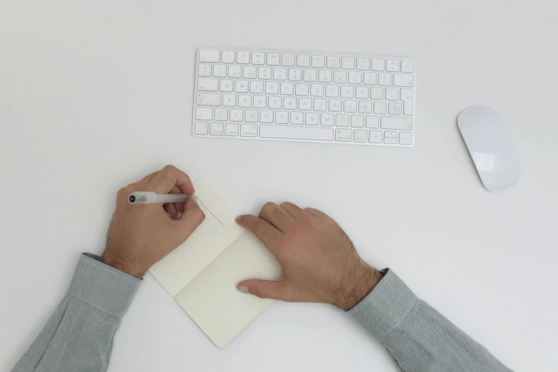 a person writing on a piece of paper next to a keyboard, white space, uploaded, item, computer aesthetic