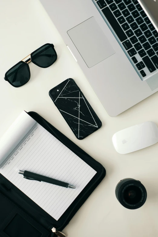 a laptop computer sitting on top of a white desk, various items, black lines, tech pattern, flatlay