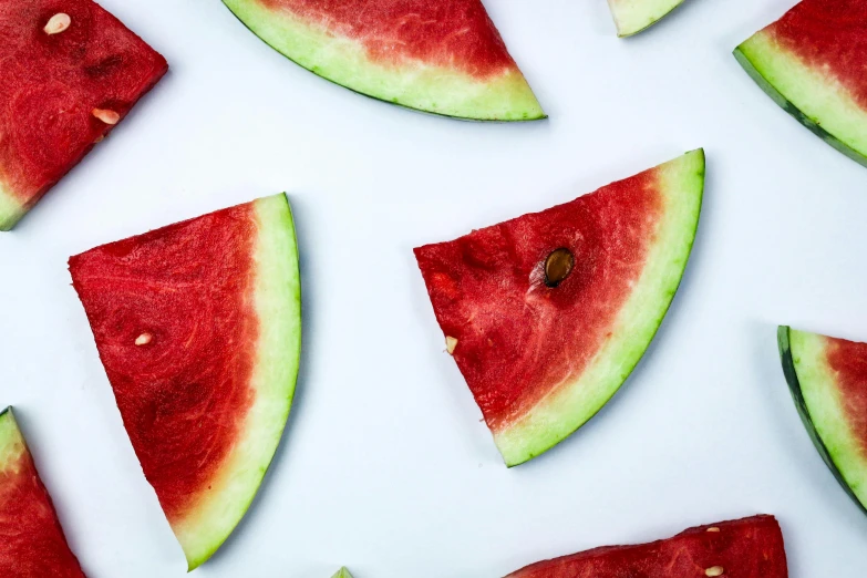 slices of watermelon on a white surface, by Julia Pishtar, trending on pexels, hurufiyya, fan favorite, 6 pack, hydration, background image