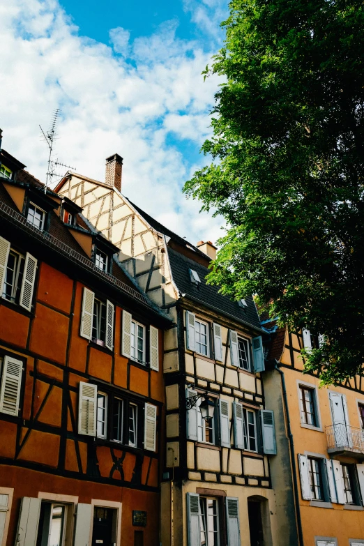 a couple of buildings that are next to each other, inspired by Albert Paris Gütersloh, unsplash contest winner, renaissance, french village exterior, ocher, summer day, conde nast traveler photo