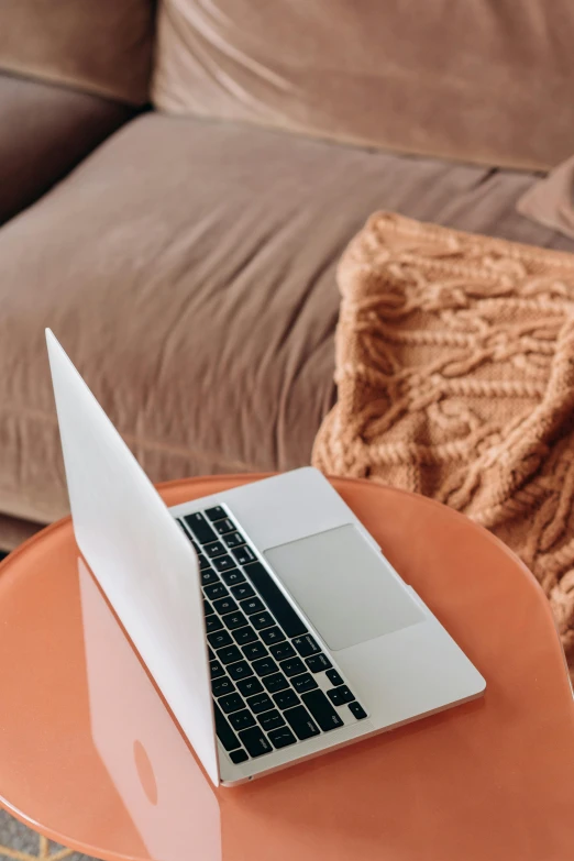 an orange table with a laptop on top of it, by Carey Morris, trending on pexels, light beige pillows, ( 3 1, technology, brown