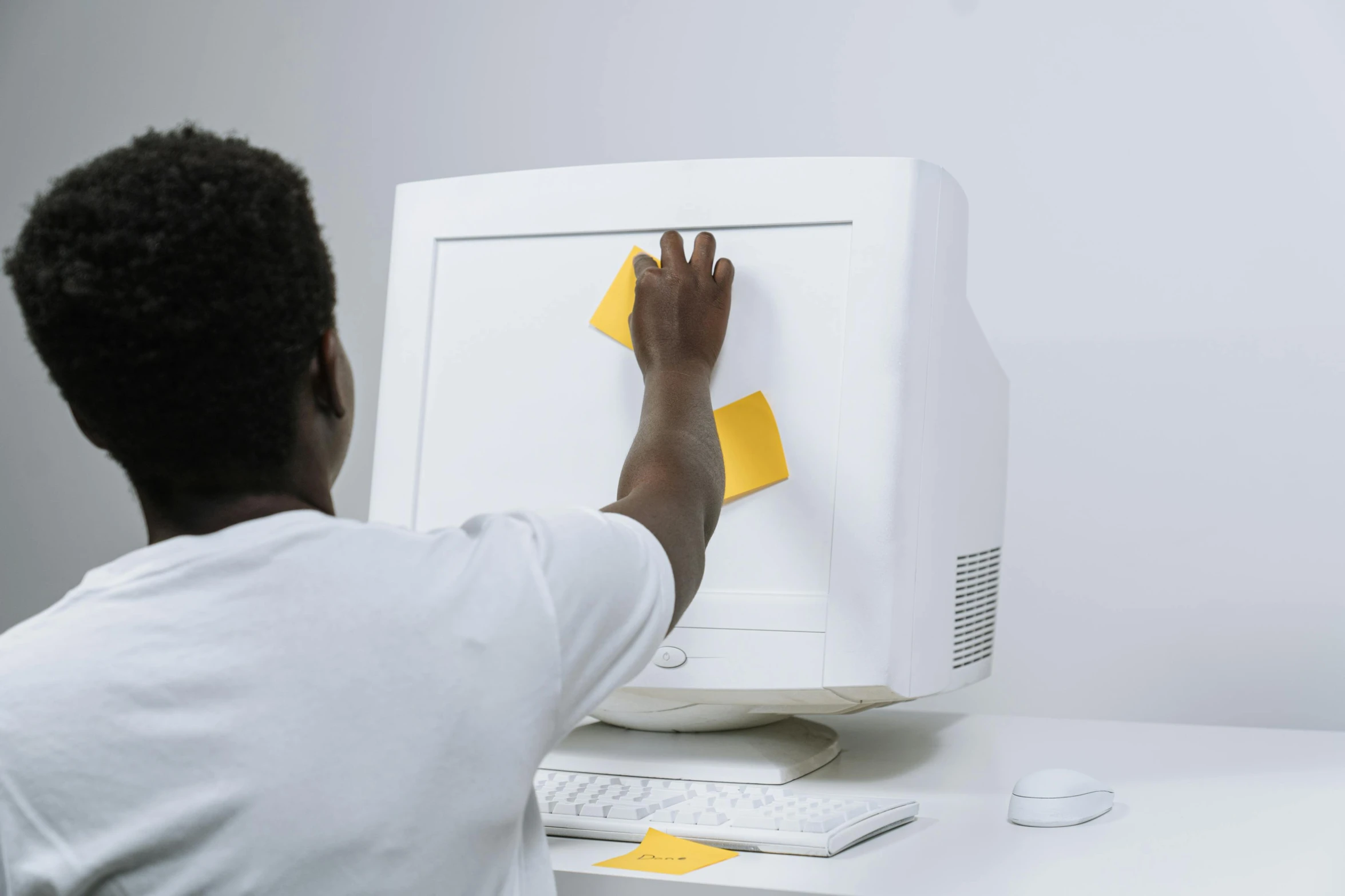 a man that is sitting in front of a computer, on a yellow paper, toggling, die - cut sticker, white hue