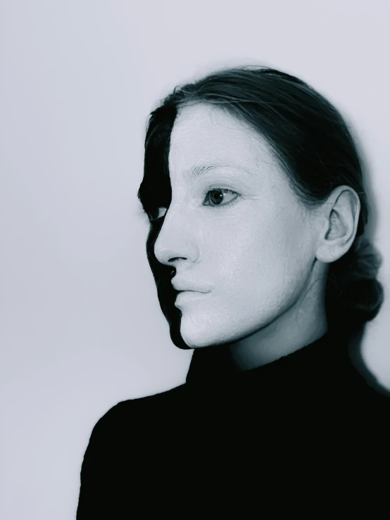 a black and white photo of a woman, inspired by Anna Füssli, half robot and half woman, face morph, taken in the 2000s, color photo