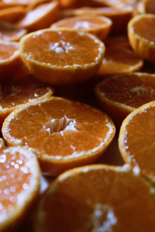 a pile of sliced oranges sitting on top of a table, slide show, belgium, detailing, soaking wet