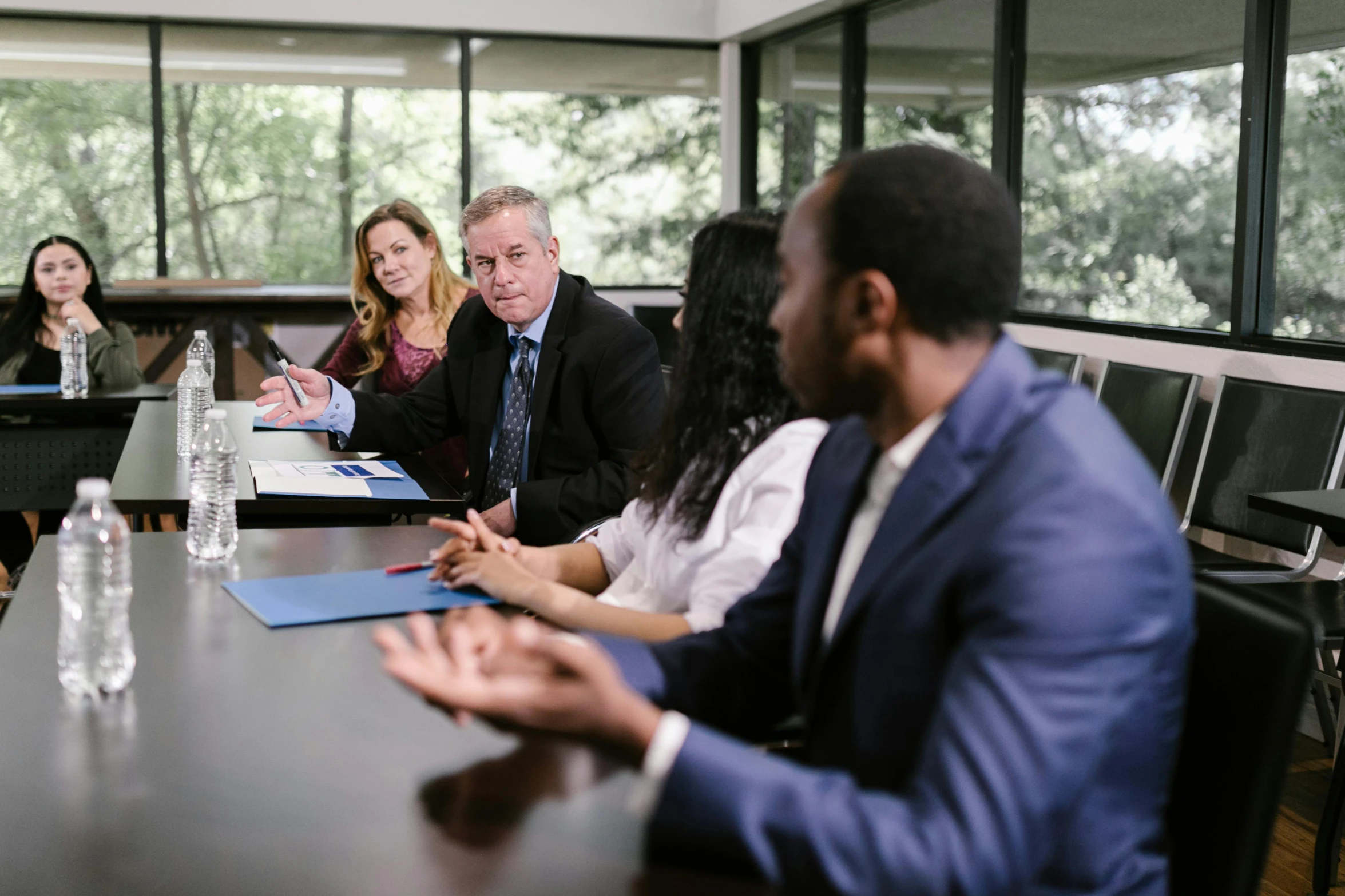 a group of people sitting around a conference table, j. h. williams iii, lynn skordal, lawyer, background image