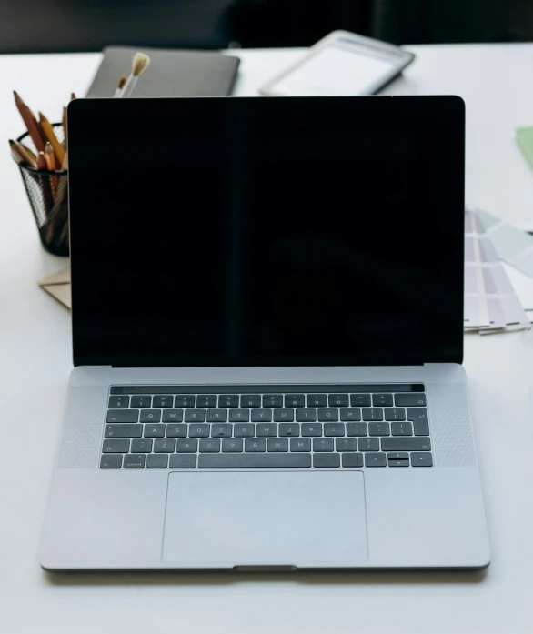 a laptop computer sitting on top of a white table, pexels, multiple stories, official screenshot, my computer icon, black