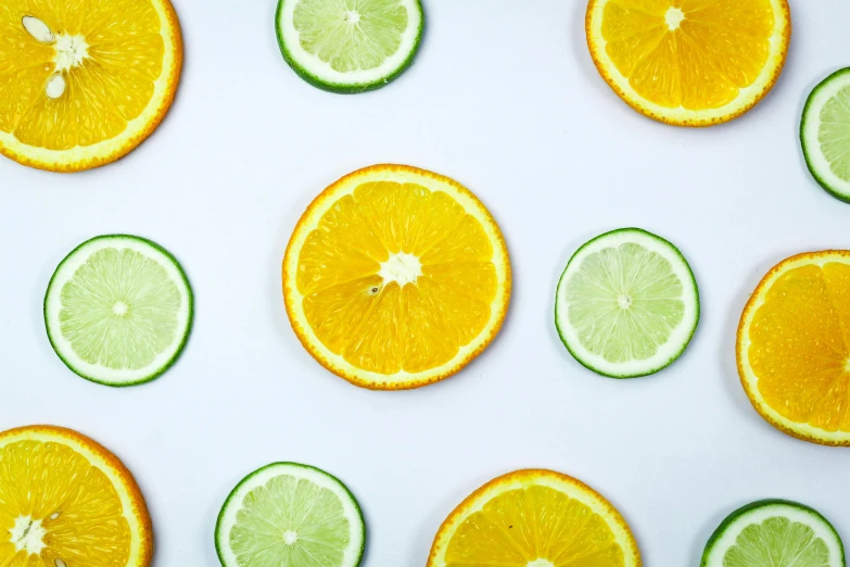 a group of sliced oranges and limes on a white surface, by Carey Morris, trending on pexels, patterned, background image, skincare, multicoloured