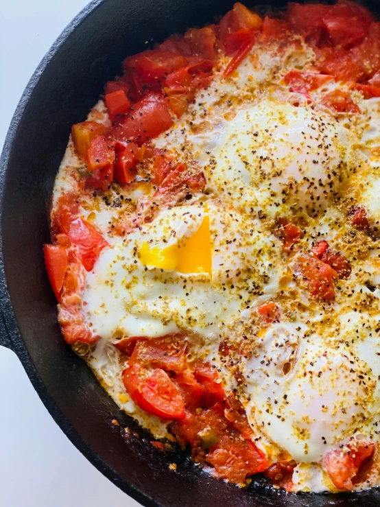 a frying pan filled with eggs and tomatoes, by Pogus Caesar, persian princess, popular on instagram, 8 k ), vine
