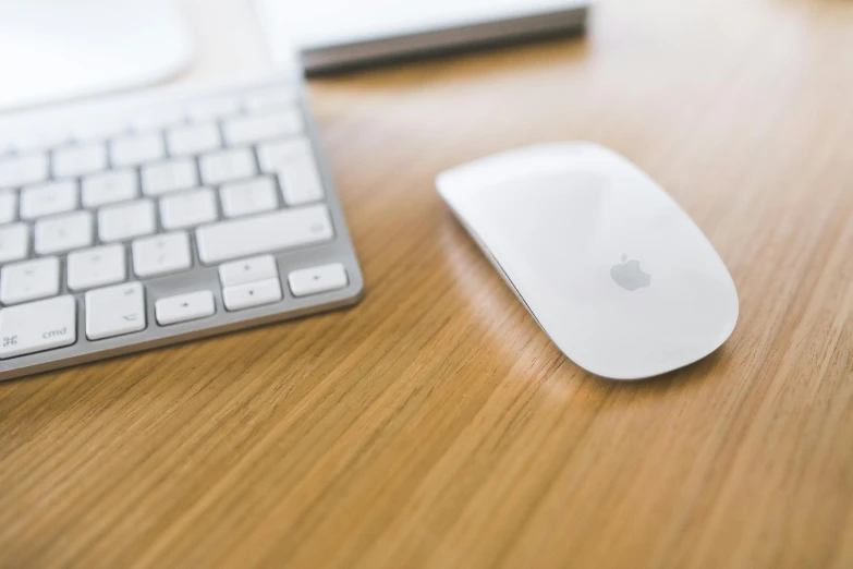 a computer mouse sitting on top of a wooden desk, unsplash, jony ive, fan favorite, glossy white metal, people at work
