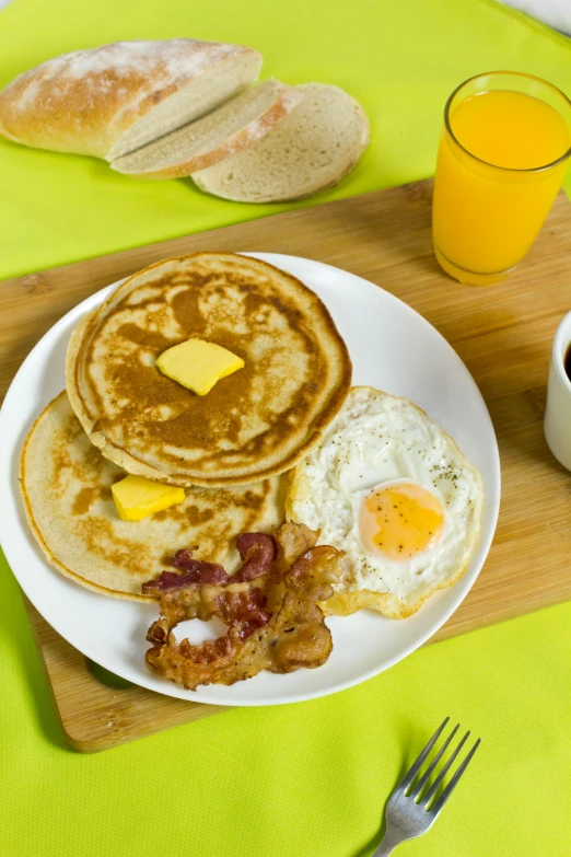 a white plate topped with pancakes and eggs, promo, ray