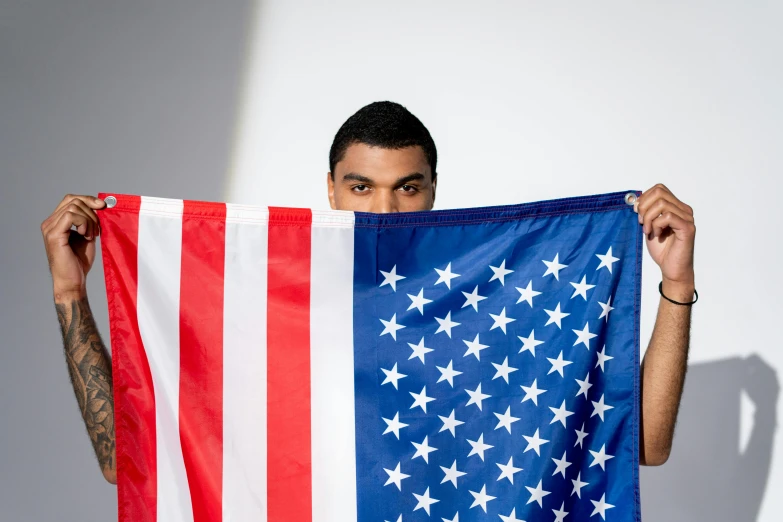 a man holding an american flag in front of his face, an album cover, unsplash, renaissance, muhammad ali, yung lean, shot in the photo studio, teddy fresh