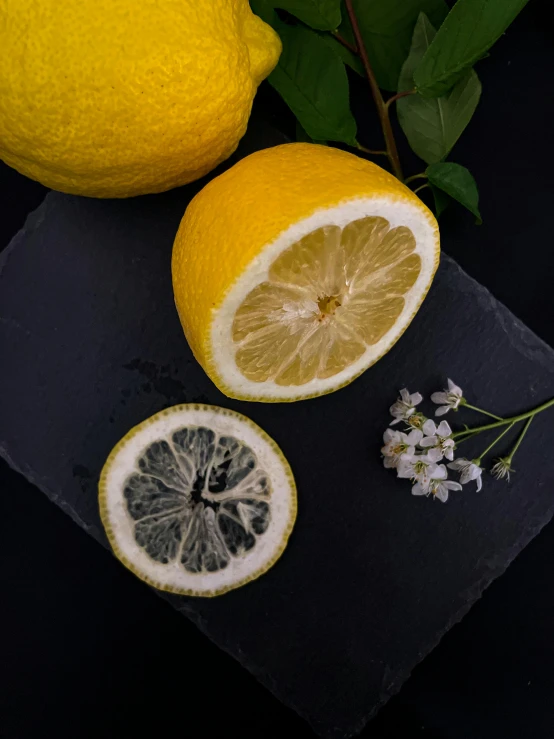 a couple of lemons sitting on top of a cutting board, inspired by Hilma af Klint, unsplash, on a dark rock background, background image, super detailed image, close up iwakura lain