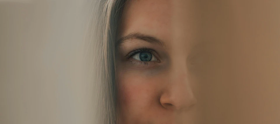 a close up of a woman's face looking at the camera, a photorealistic painting, by Adam Marczyński, pexels contest winner, woman's face looking off camera, light grey-blue eyes, hyperrealistic flickr:5, half face