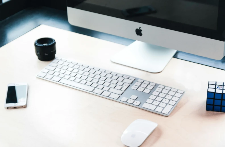 a computer monitor sitting on top of a desk next to a keyboard, unsplash, apple design, silver accessories, zoomed in, designer product