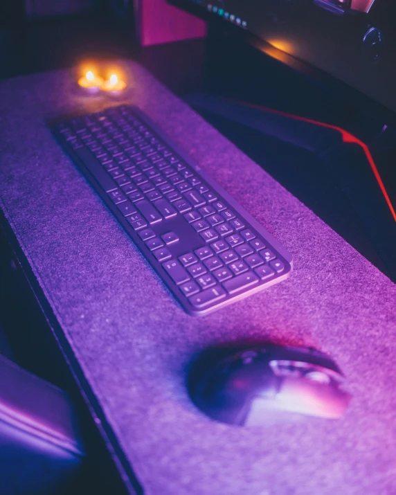a computer desk with a keyboard and mouse, by Adam Marczyński, unsplash, computer art, cybertruck, purple and red, panoramic shot, felt