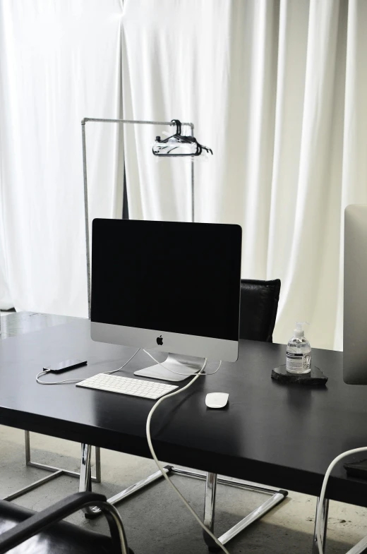 a computer sitting on top of a wooden desk, clamp shell lighting, studio kyoto, clean and neat, open office