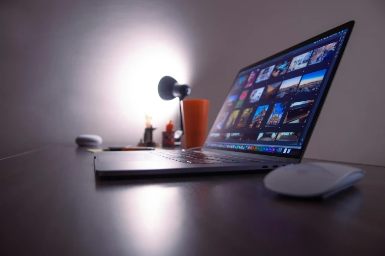 a laptop computer sitting on top of a wooden desk, pexels, video art, purple ambient light, home video, thumbnail, shot on sony a 7