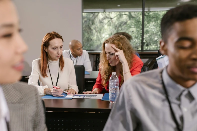 a group of people sitting around a table, profile image, digital image, teaching, focused photo