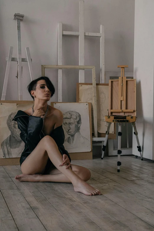 a woman sitting on the floor in front of a painting, inspired by Hedi Xandt, pexels contest winner, stands at a his easel, ilya kuvshinov and artgerm, 5 0 0 px models, full body picture