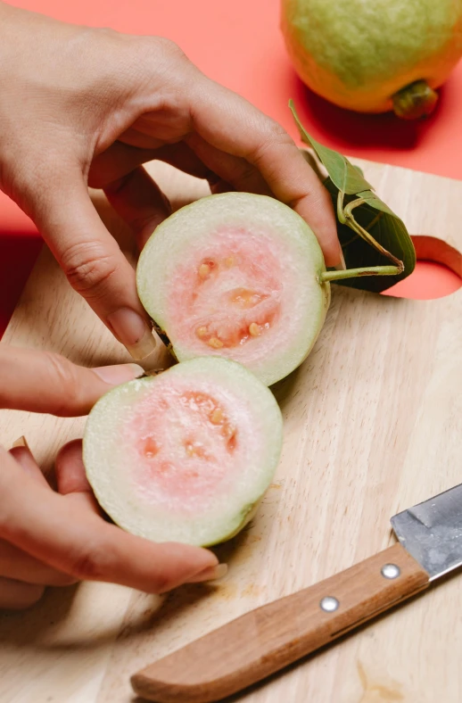 a person cutting up a piece of fruit on a cutting board, fig leaves, holding it out to the camera, 王琛, multiple stories