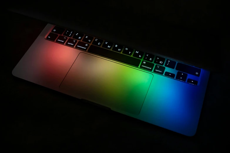 a close up of a laptop in a dark room, a computer rendering, by Jason Felix, unsplash, color field, rgb keyboard, rainbow sheen, on black background, soft coloured gel lighting