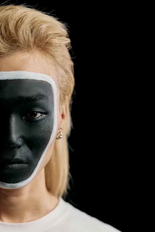 a woman with black paint on her face, a hyperrealistic painting, by Adam Marczyński, trending on pexels, blonde swedish woman, part robot and part black human, white on black, face covers half of the frame