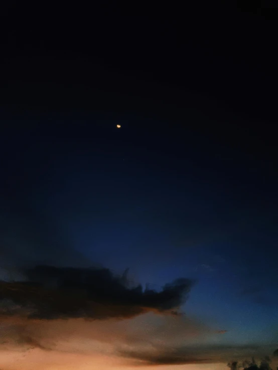 the sun is setting over a body of water, by Ryan Pancoast, hurufiyya, lunar eclipse, slightly pixelated, overcast sky, low quality photo