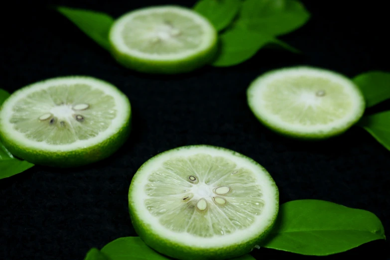 a group of limes sitting on top of a black surface, detailed product image, glowing mint face, natural complexion, thumbnail