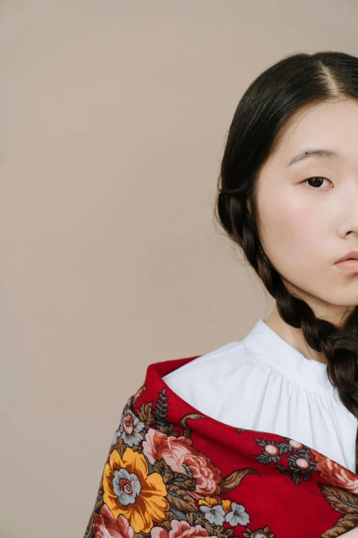 a close up of a person wearing a shawl, an album cover, inspired by Kim Tschang Yeul, trending on pexels, hyperrealism, girl with plaits, inspired in balthus, young asian girl, patterned clothing