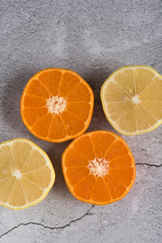 oranges and lemons cut in half on a gray surface, by Carey Morris, trending on unsplash, made of glazed, medium format, vivid lines, grey