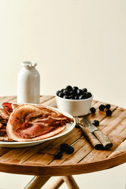 a plate of food sitting on top of a wooden table, a portrait, unsplash, blueberries, bacon, flat pancake head, 15081959 21121991 01012000 4k