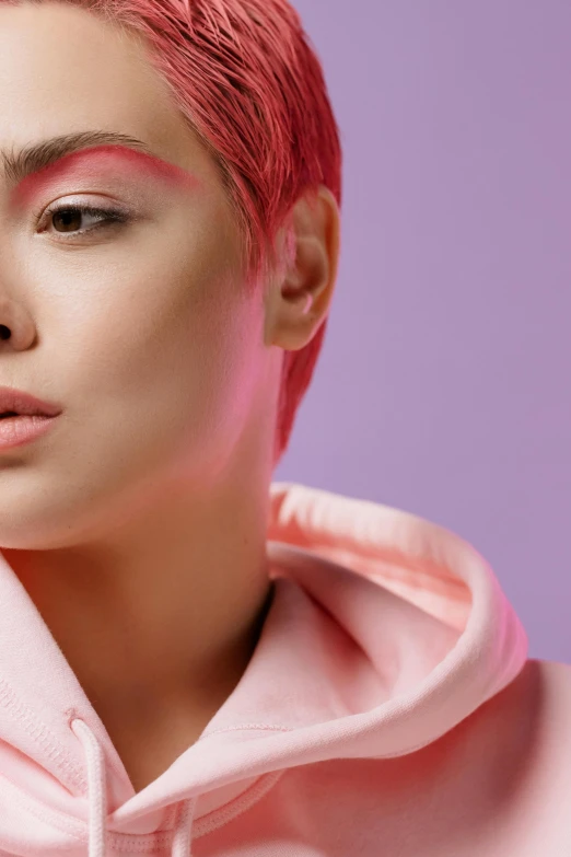 a woman with pink hair wearing a pink hoodie, inspired by Cosmo Alexander, trending on pexels, asian face, nonbinary model, left eye red stripe, short platinum hair tomboy