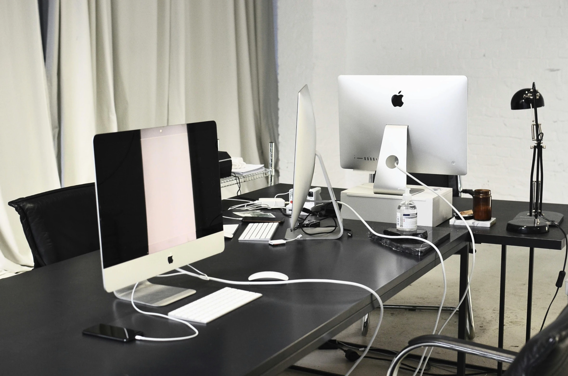 a couple of computers sitting on top of a desk, inspired by Marina Abramović, unsplash, theatre equipment, apple store, ignant, satisfying cable management