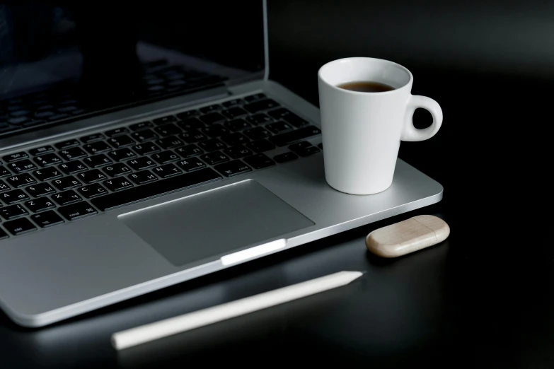 a cup of coffee next to a laptop computer, a computer rendering, inspired by Jan Müller, minimalism, 9 9 designs, close up portrait shot, thin porcelain, a wooden