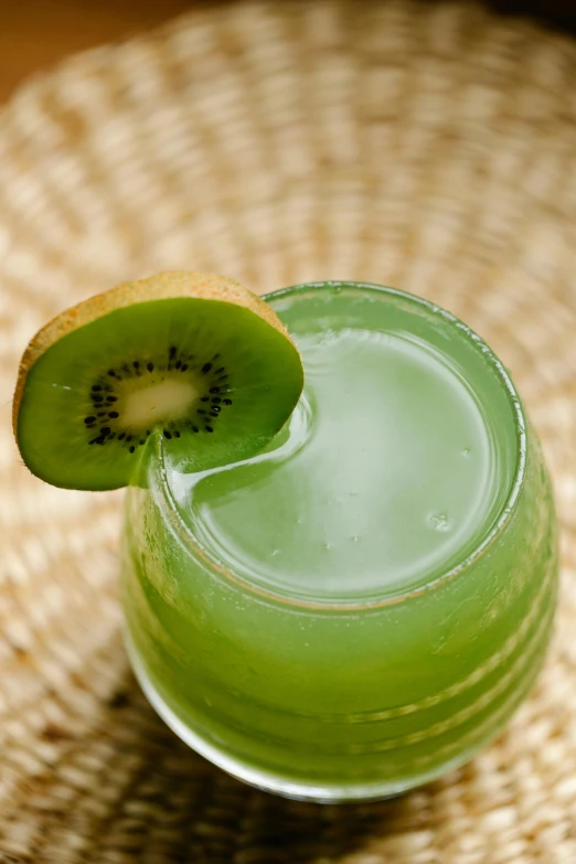 a kiwi drink with a slice of kiwi on the rim, inspired by Kanō Tan'yū, zoomed in, green mist, fruit, top down shot