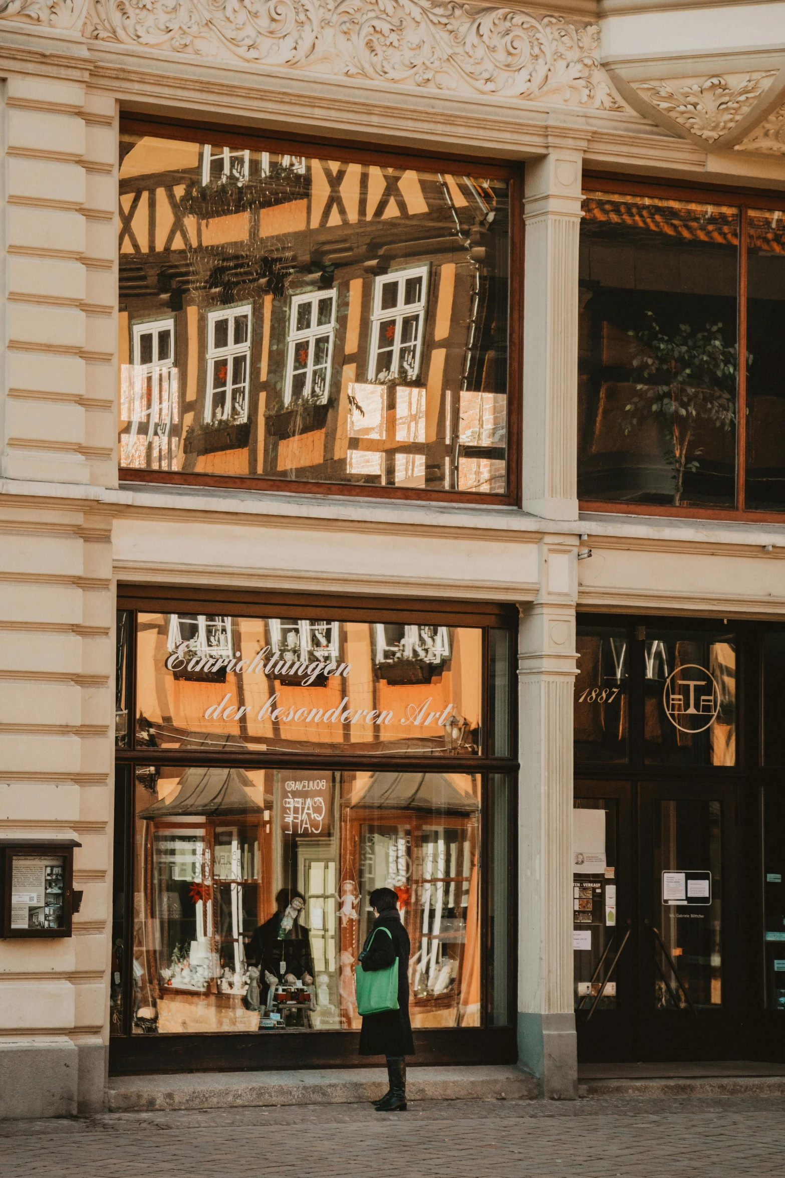 a person on a skateboard in front of a building, by Emma Andijewska, pexels contest winner, art nouveau, 12th century apothecary shop, reflective windows, inspect in inventory image, detmold charles maurice