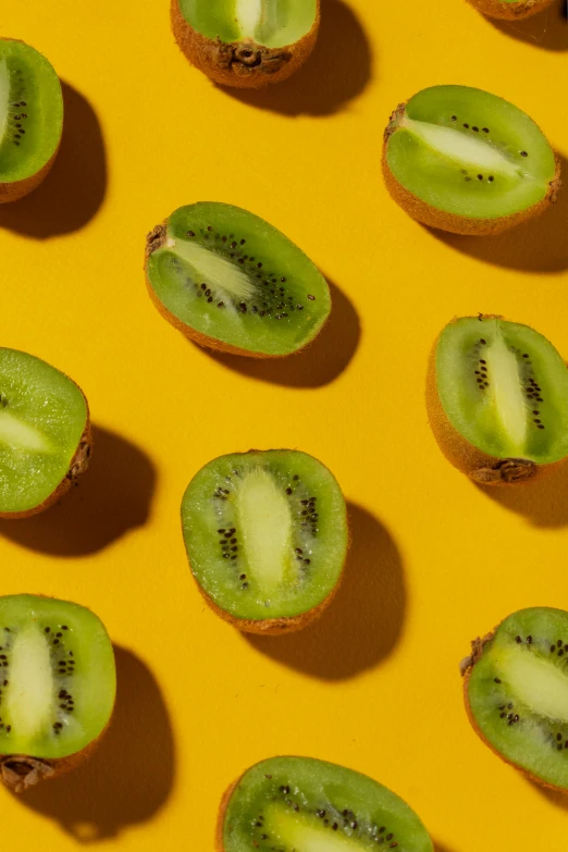 a close up of kiwi slices on a yellow surface, trending on pexels, “berries, on clear background, made of food, assemble