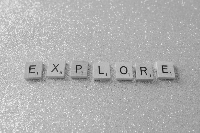 a black and white photo of the word explore, a black and white photo, inspired by Vija Celmins, pexels, sparkly, board games, japan deeper travel exploration, museum photo
