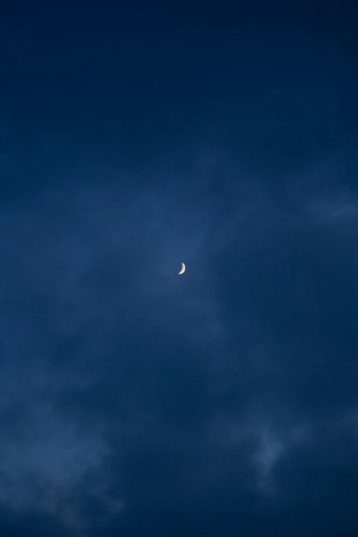 the moon is shining through the dark clouds, by Jacob Toorenvliet, unsplash, ✨🕌🌙, just after rain, very minimalistic, crescent moon