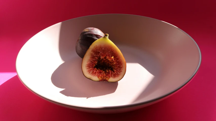 a fig sitting on top of a white plate, a raytraced image, inspired by Frederick Goodall, pexels contest winner, in a red dish, global illumination lighting, middle close up composition, product introduction photo