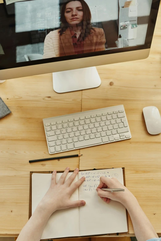 a woman sitting at a desk in front of a computer, trending on pexels, lined paper, swedish writing, 9 9 designs, a wooden