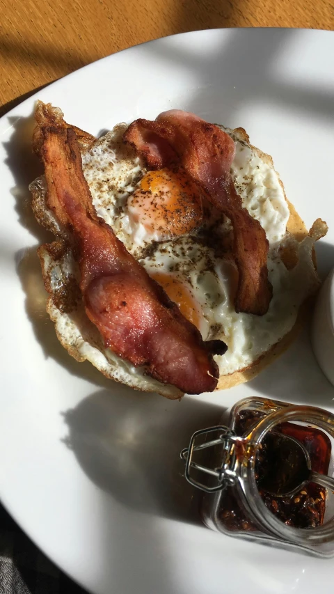 a close up of a plate of food on a table, breakfast, bacon, shot with iphone 1 0, silver egg cup