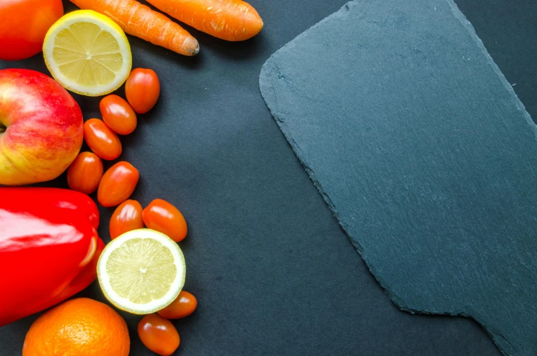 a cutting board surrounded by fruits and vegetables, pexels contest winner, dark grey and orange colours, profile image, chalkboard, background image